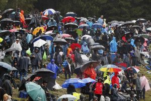 fans under umbrellas during a