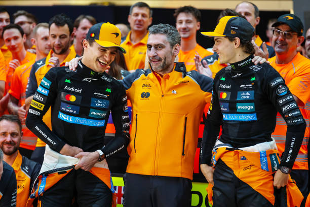 Lando Norris of Great Britain and McLaren and Oscar Piastri of Australia and McLaren celebrate with McLaren Team Principal Andrea Stella during the...